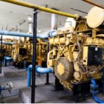 Image of a yellow gas turbine engine in a facility